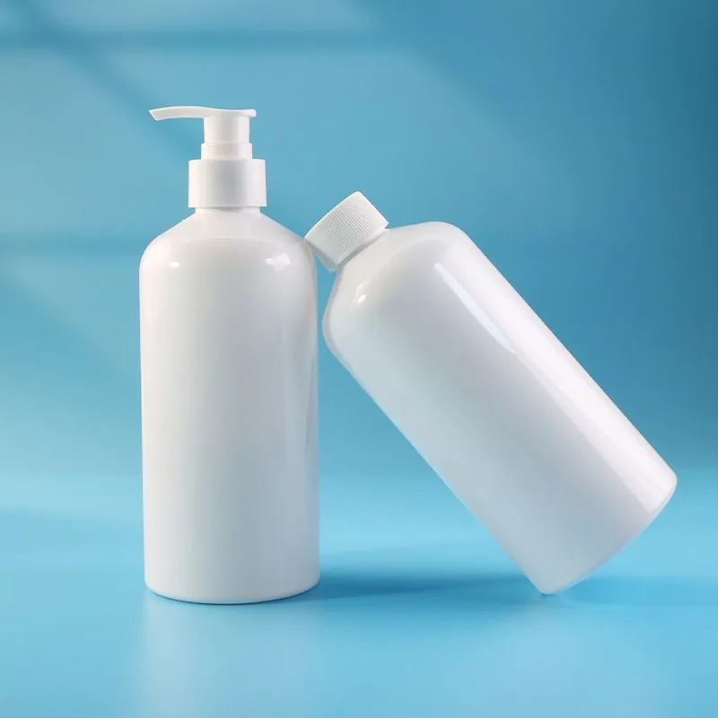 Two white shampoo bottles on a blue ground
